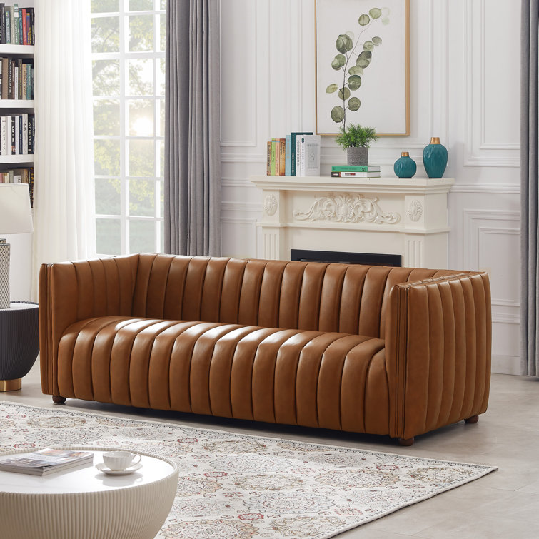 Tufted leather deals settee